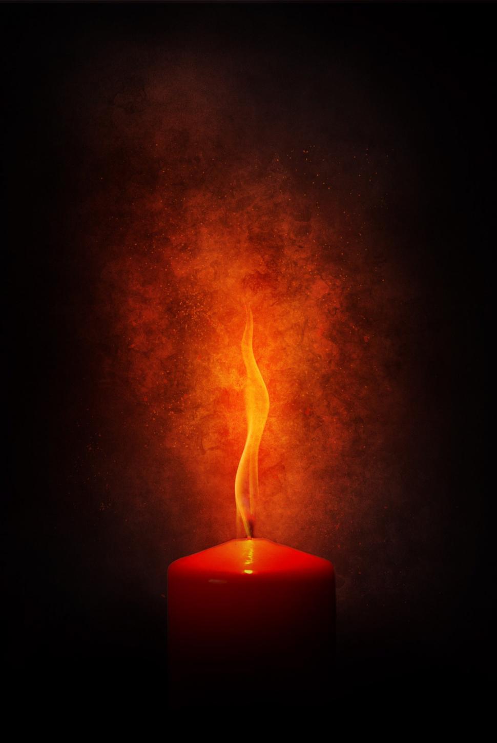 Free Image of Illuminated Candle in Dark With Red Background 