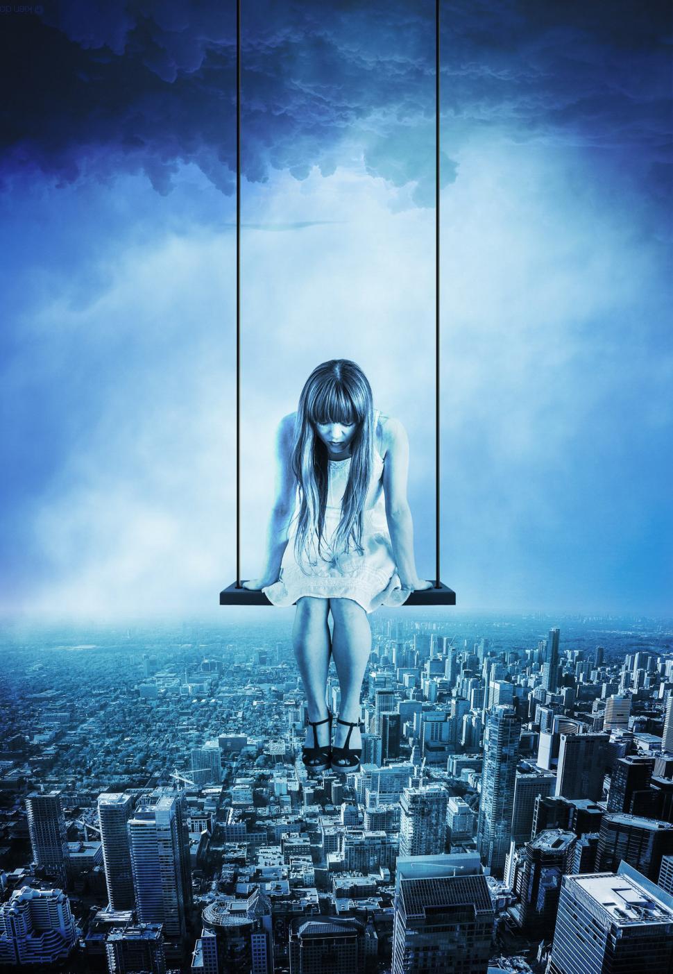 Free Image of Woman Sitting on Swing in City 