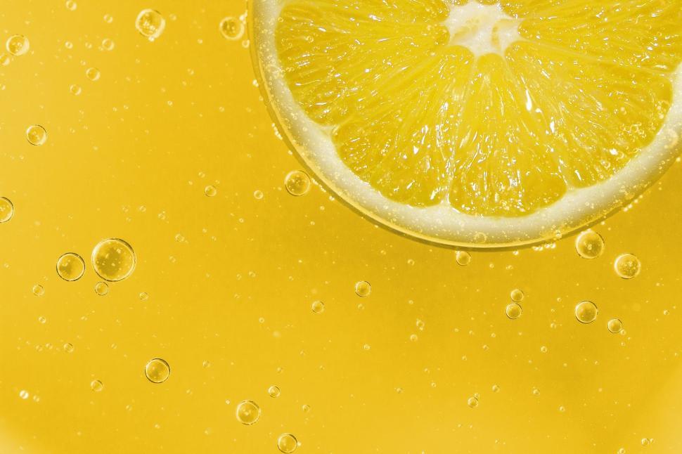 Free Image of Slice of Lemon on Yellow Table 