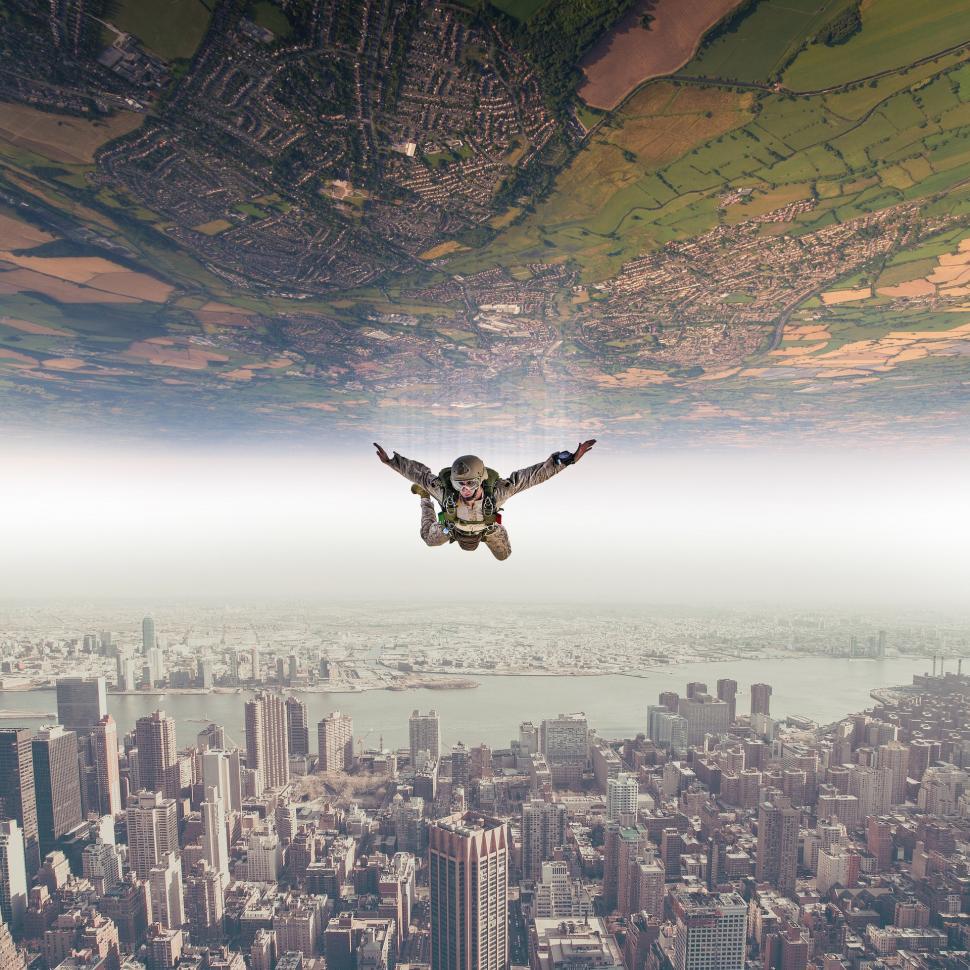 Free Image of Man Flying Through the Air Over a City 