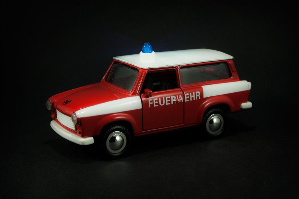 Free Image of Red and White Toy Truck With Blue Top 