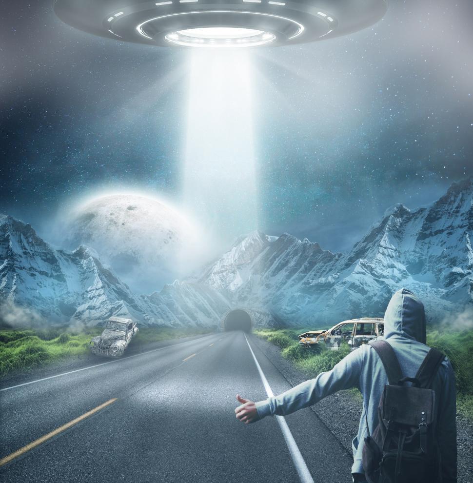 Free Image of Man With Backpack Standing in Front of Alien Spaceship 