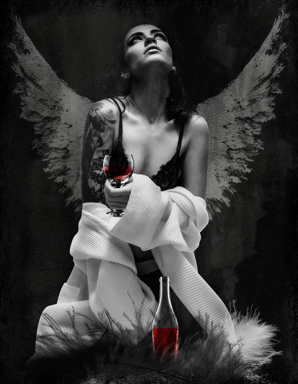 Free Image of Woman With Wings Holding a Bottle of Wine 
