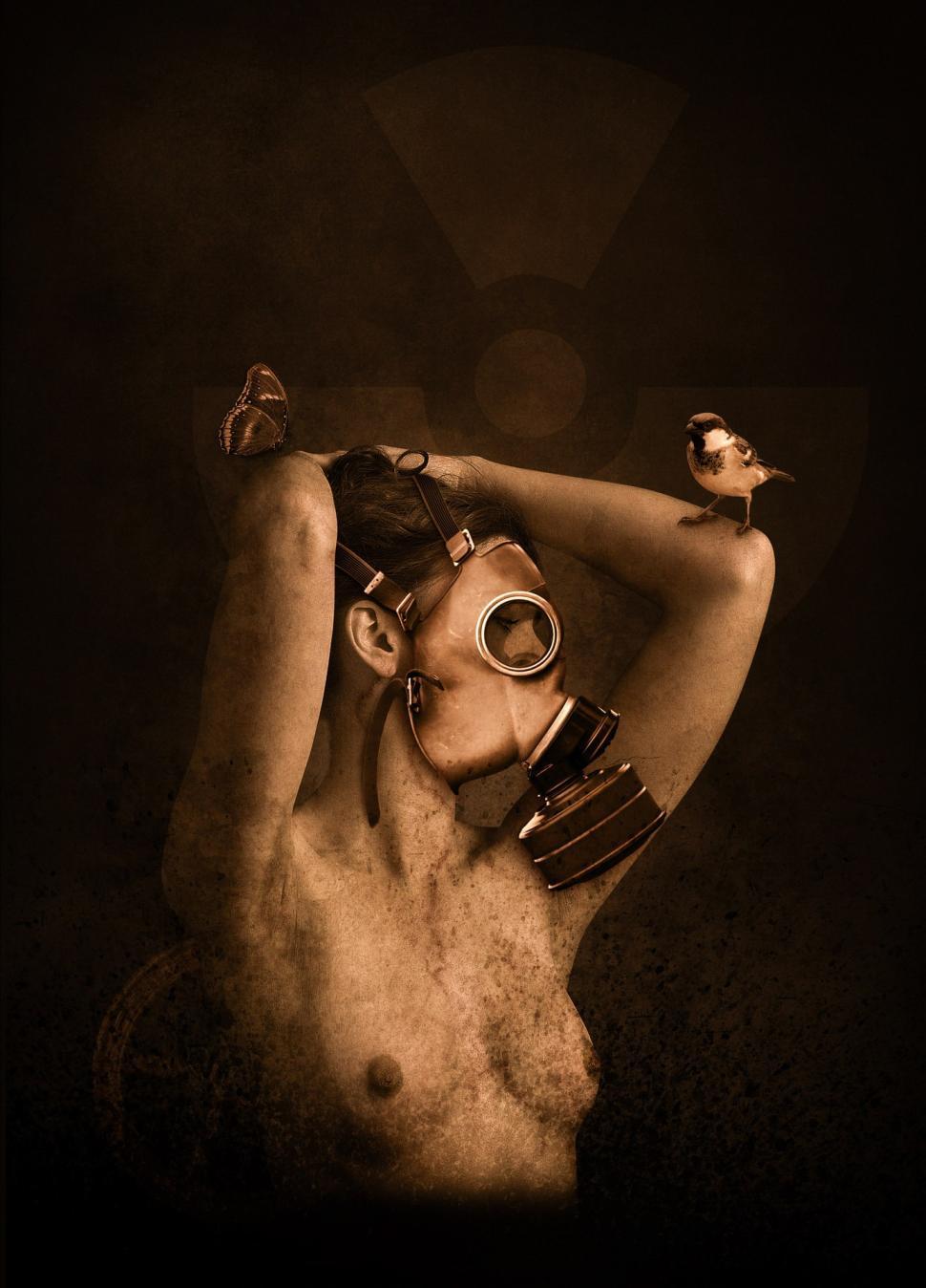 Free Image of Man With Gas Mask and Bird on Shoulder 