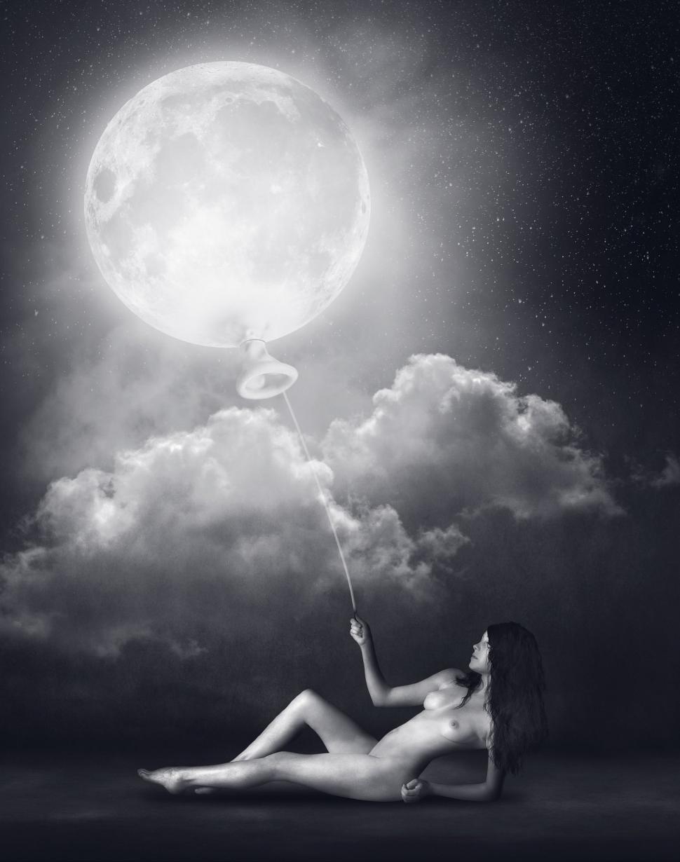 Free Image of Woman Sitting Holding String in Front of Full Moon 