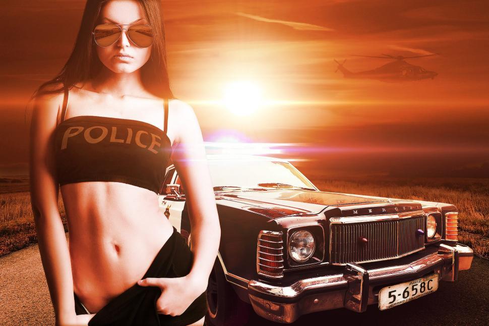 Free Image of Young Woman Standing Next to Police Car 