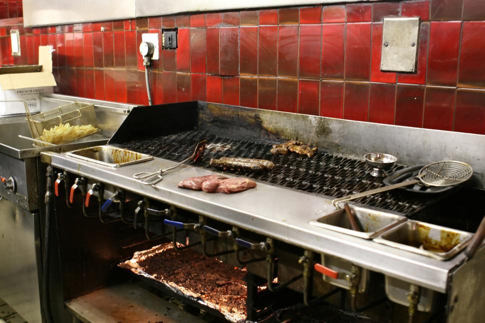 Free Image of Kitchen With Red Tiles and Grill Cooking Food 