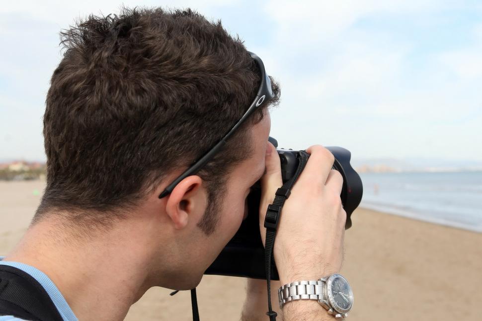 Free Image of Man Taking Picture of Beach With Camera 