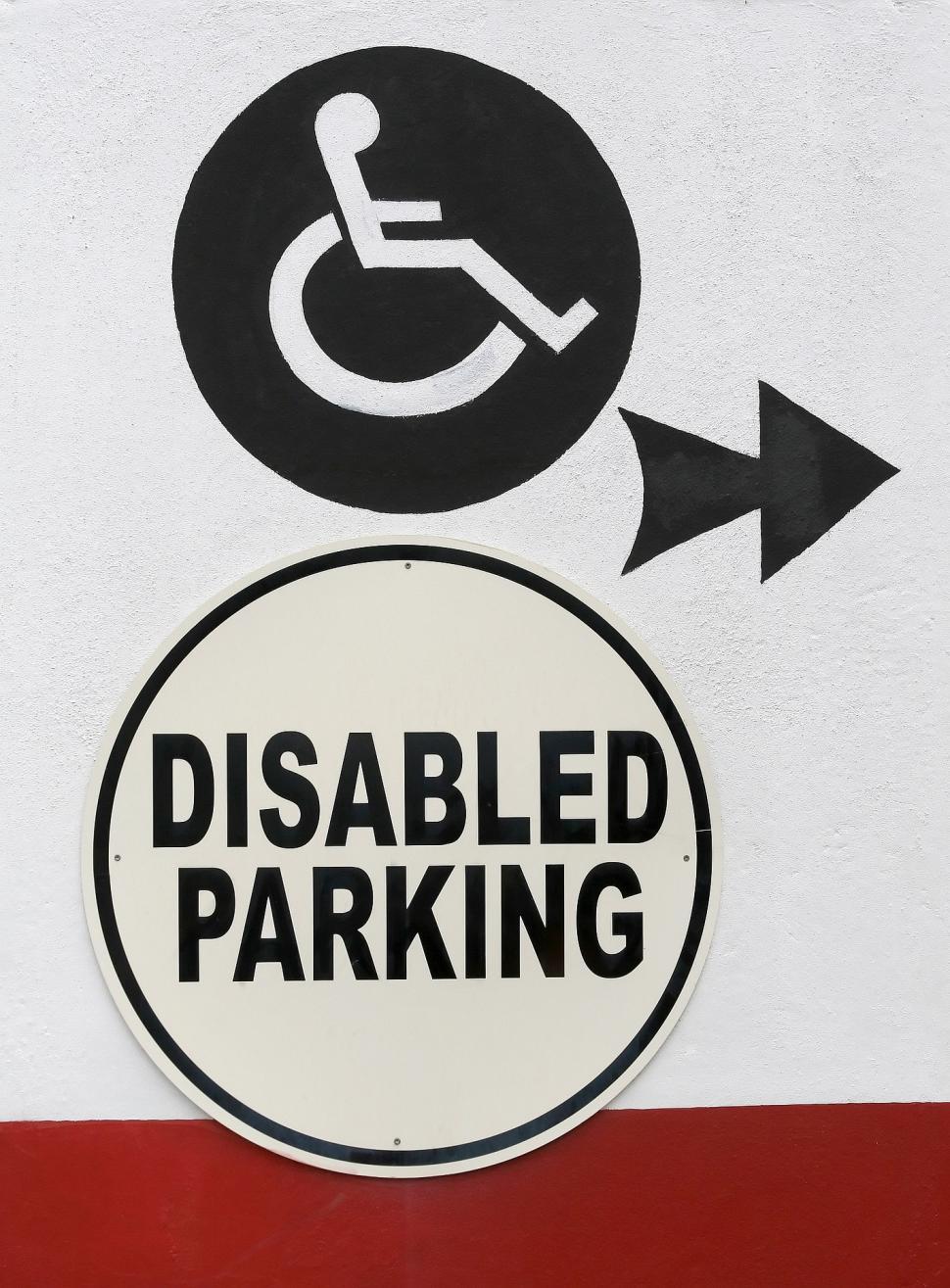 Free Image of Handicapped Parking Sign With Arrows Pointing in Different Directions 