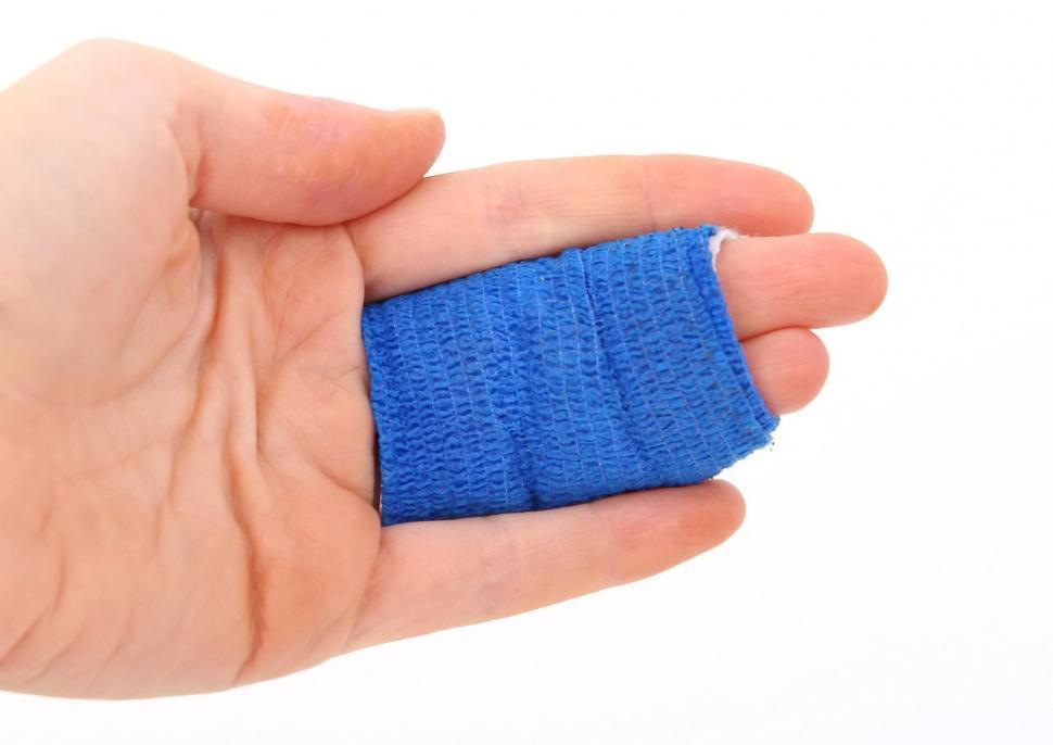 Free Image of Hand Holding Blue Piece of Cloth 