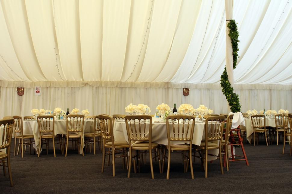 Free Image of Large White Tent With Tables and Chairs Set Up for Event 