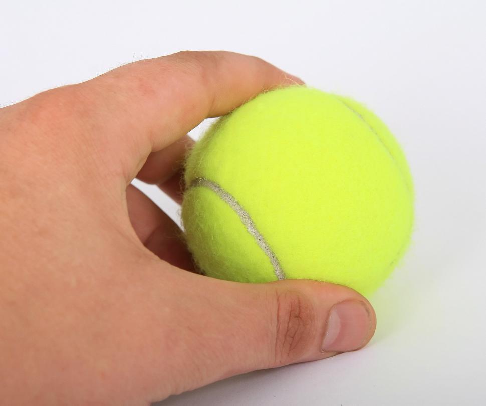 Free Image of Person Holding Tennis Ball 