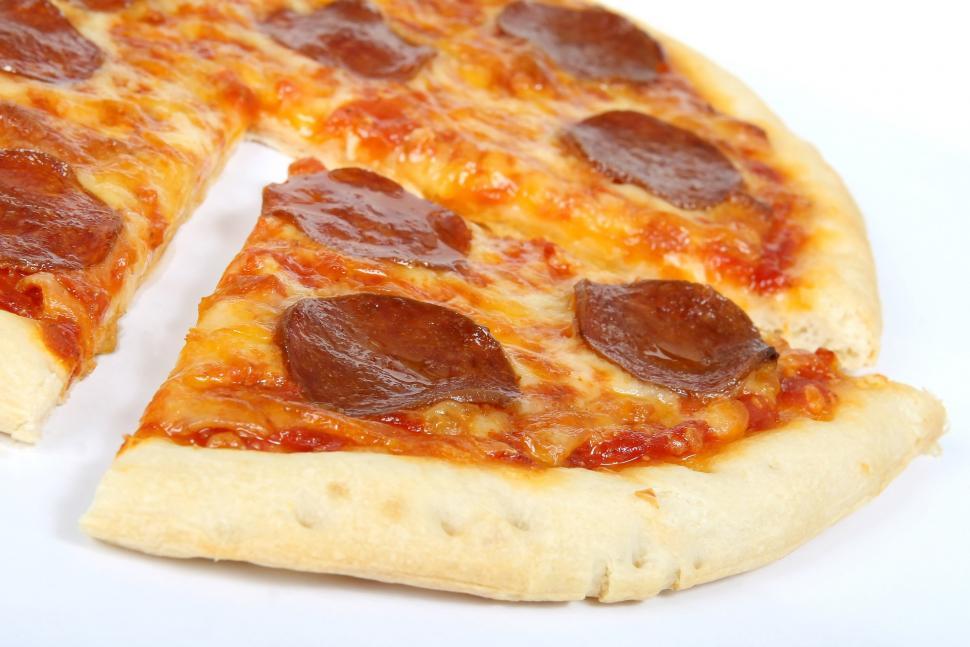 Free Image of Half of Pepperoni Pizza on White Surface 