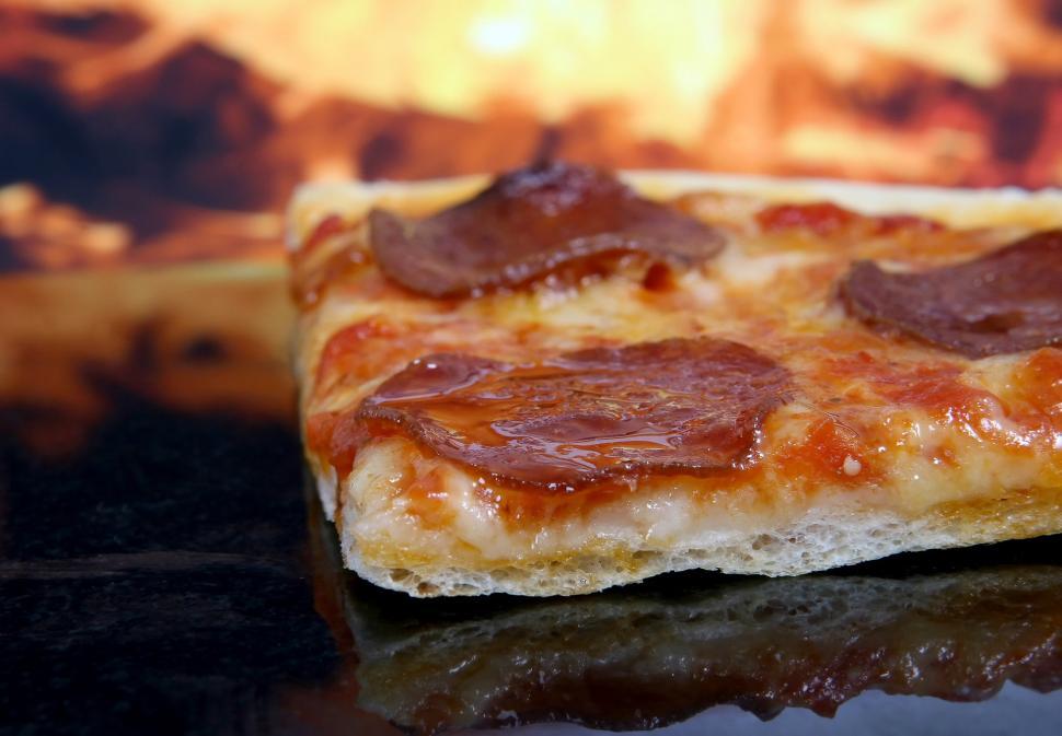 Free Image of Close Up of a Slice of Pizza on a Table 