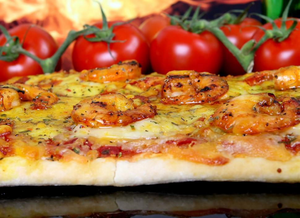 Free Image of Pizza Resting on Cheese-Covered Pan 