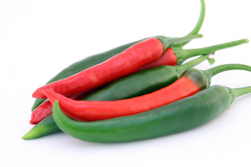 Free Image of Three Green and Red Peppers on a White Background 