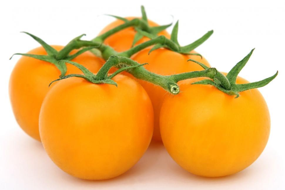Free Image of Group of Four Orange Tomatoes Stacked Together 