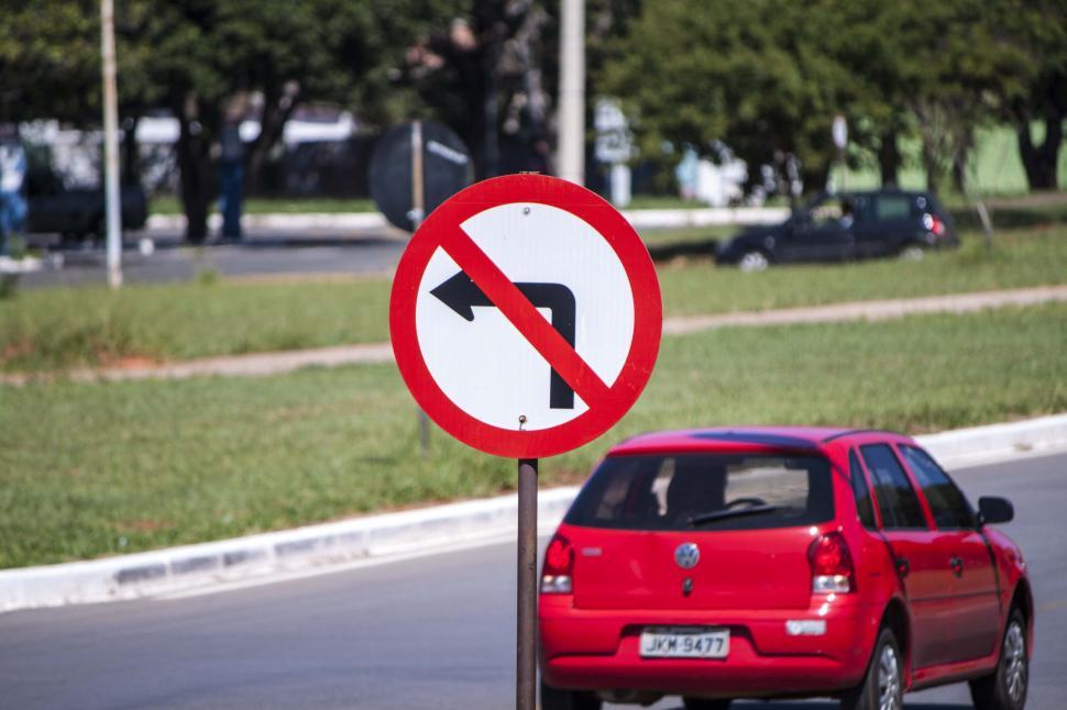 Free Image of No left turn sign with car in background 