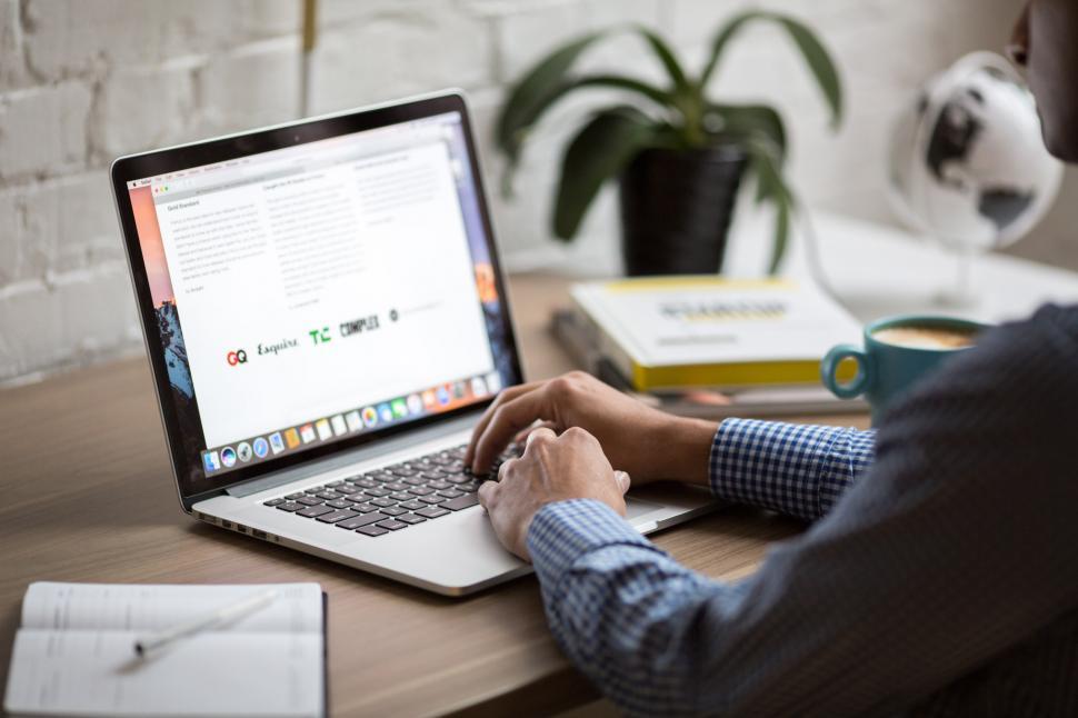 Free Image of Man Using Macbook Air 