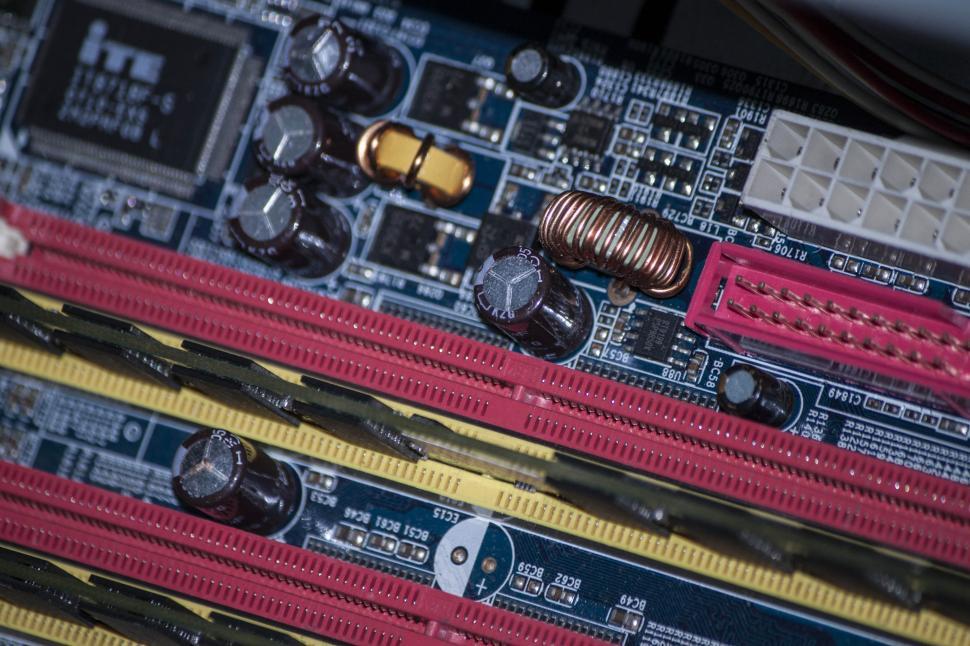 Free Image of Close Up of a Computer Motherboard With Many Wires 