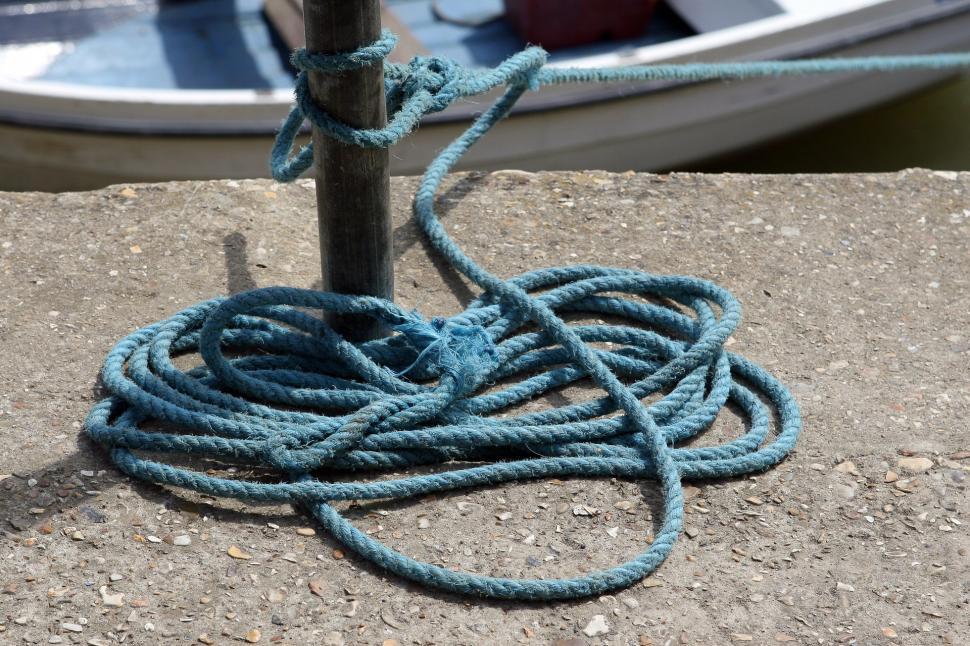 Free Image of Rope Tied to Pole Next to Boat 
