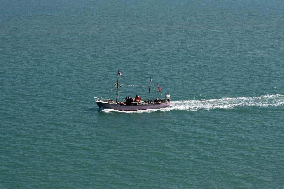 Free Image of Small Boat Drifting in Vast Ocean 