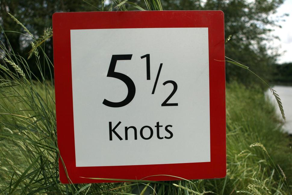 Free Image of Red and White Sign Displaying 5 / 2 Knots 