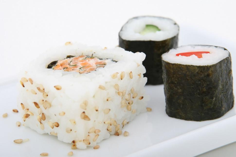 Free Image of White Plate Topped With Sushi and Rice 