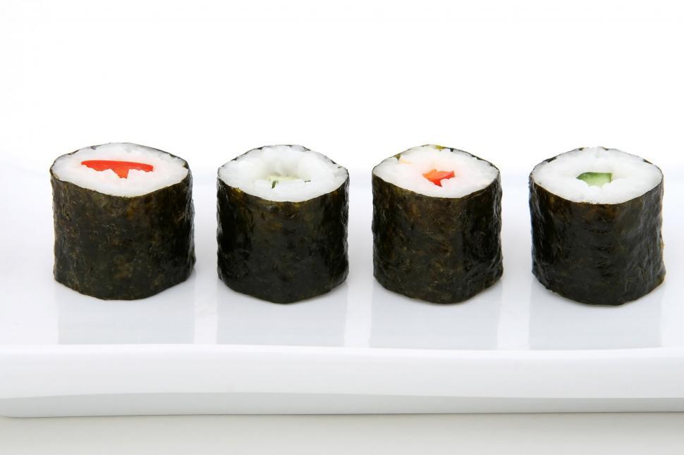 Free Image of Four Sushi Rolls on a White Plate 