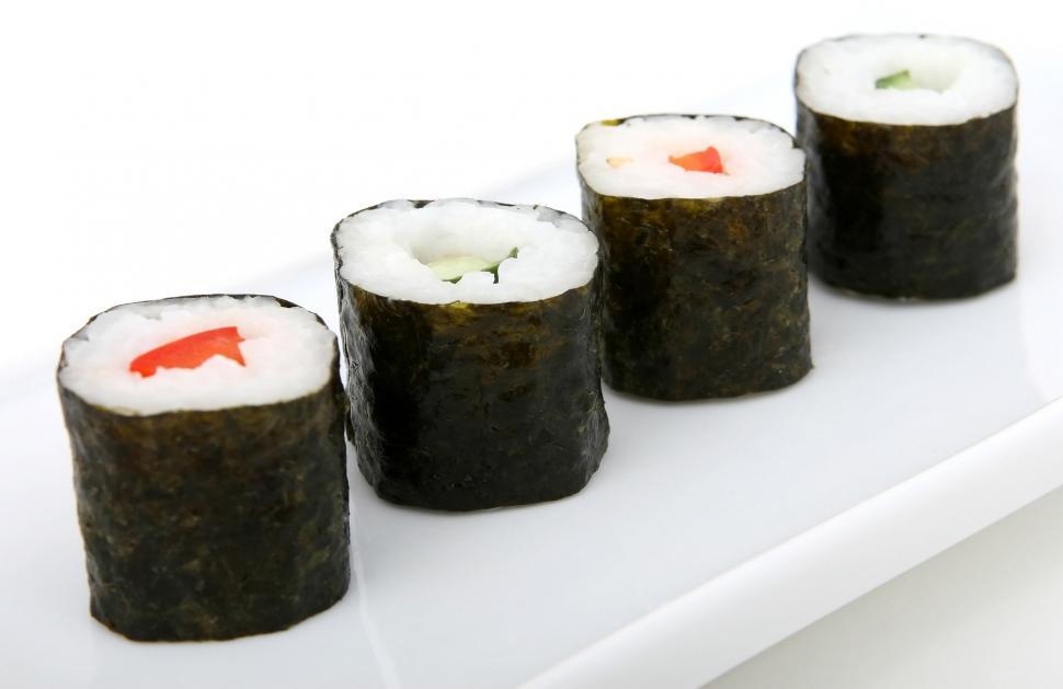 Free Image of White Plate With Sushi Rolls Covered in Sauce 