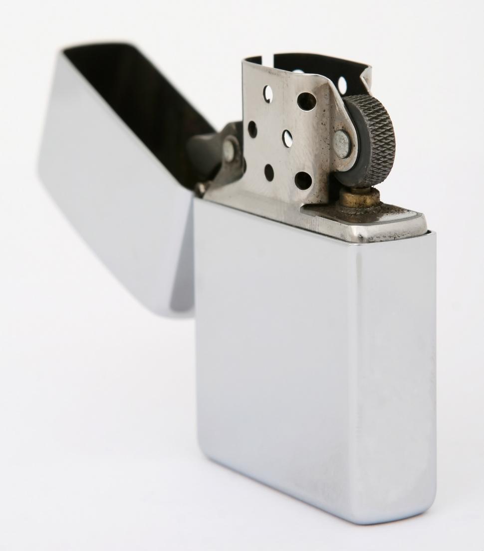 Free Image of Silver Lighter With Black Handle on White Background 