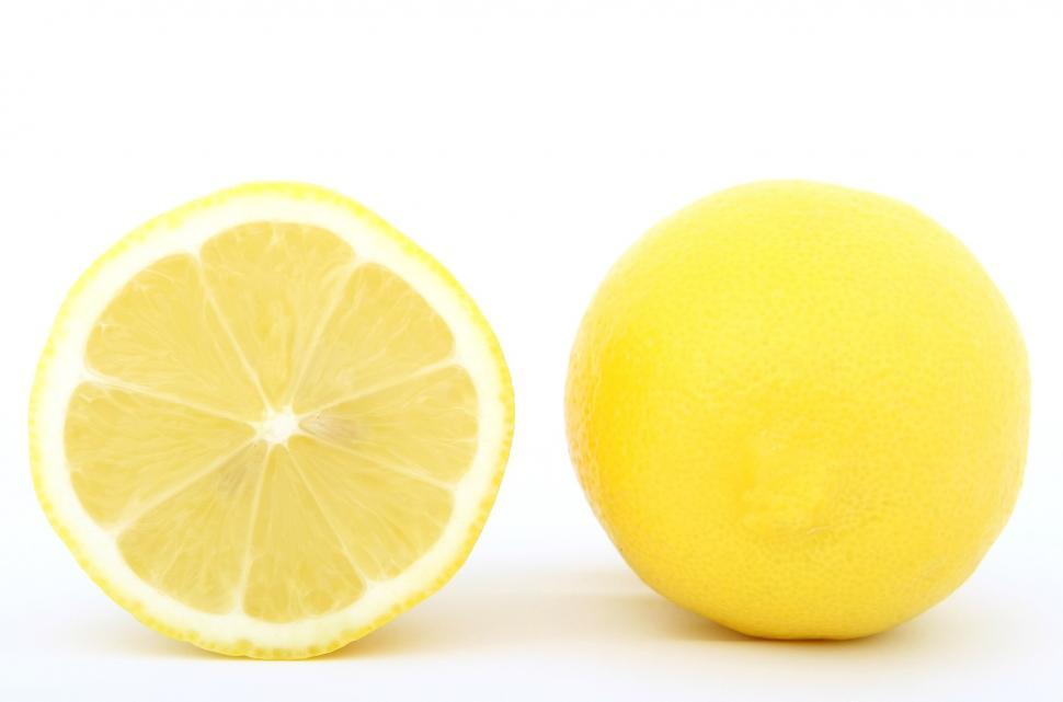Free Image of Whole Lemon Next to Cut Half Lemon 