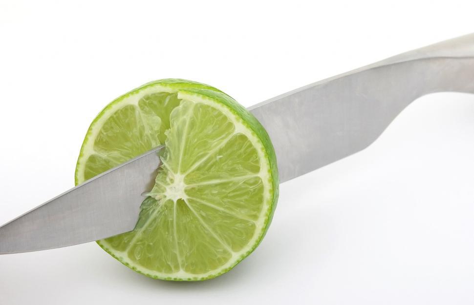 Free Image of Lime Cut in Half With Knife Sticking Out 