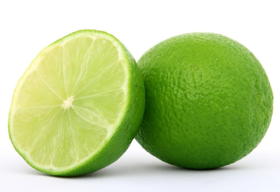 Free Image of Halved Lime Beside Whole Lime 