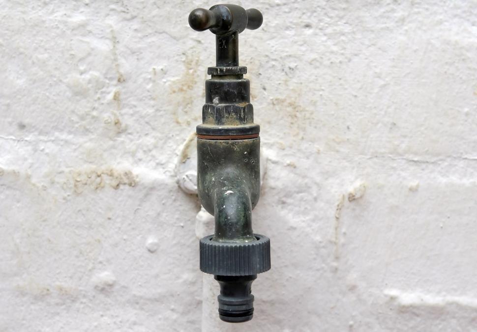 Free Image of Water Faucet Mounted to White Wall 