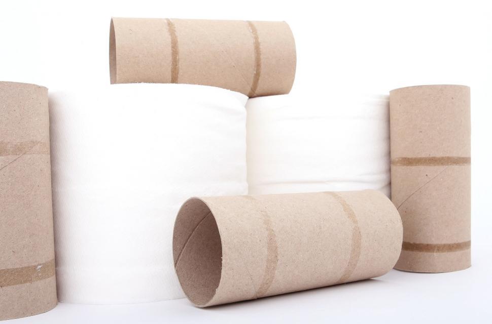 Free Image of Rows of Toilet Paper Against Wall 