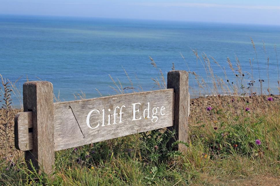 Free Image of Wooden Sign on Grass Hillside 