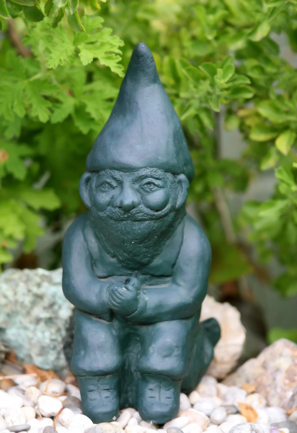 Free Image of Garden Gnome Sitting on Rock 