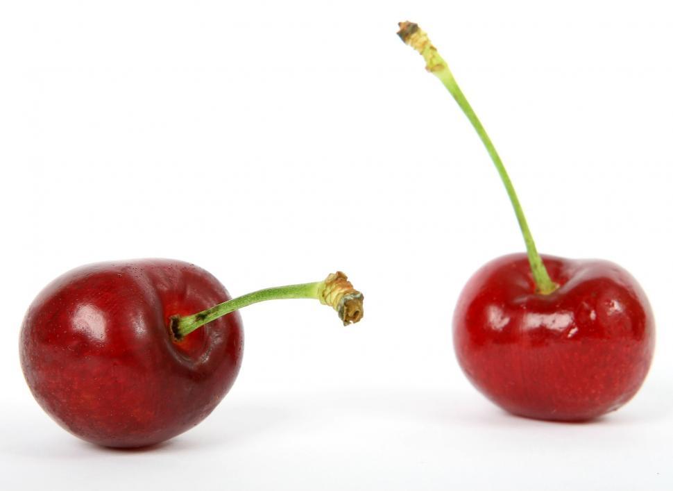 Free Image of Two Cherries Sitting Together 