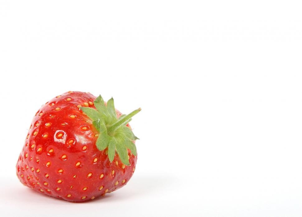 Free Image of Red Strawberry With Green Stem on White Background 