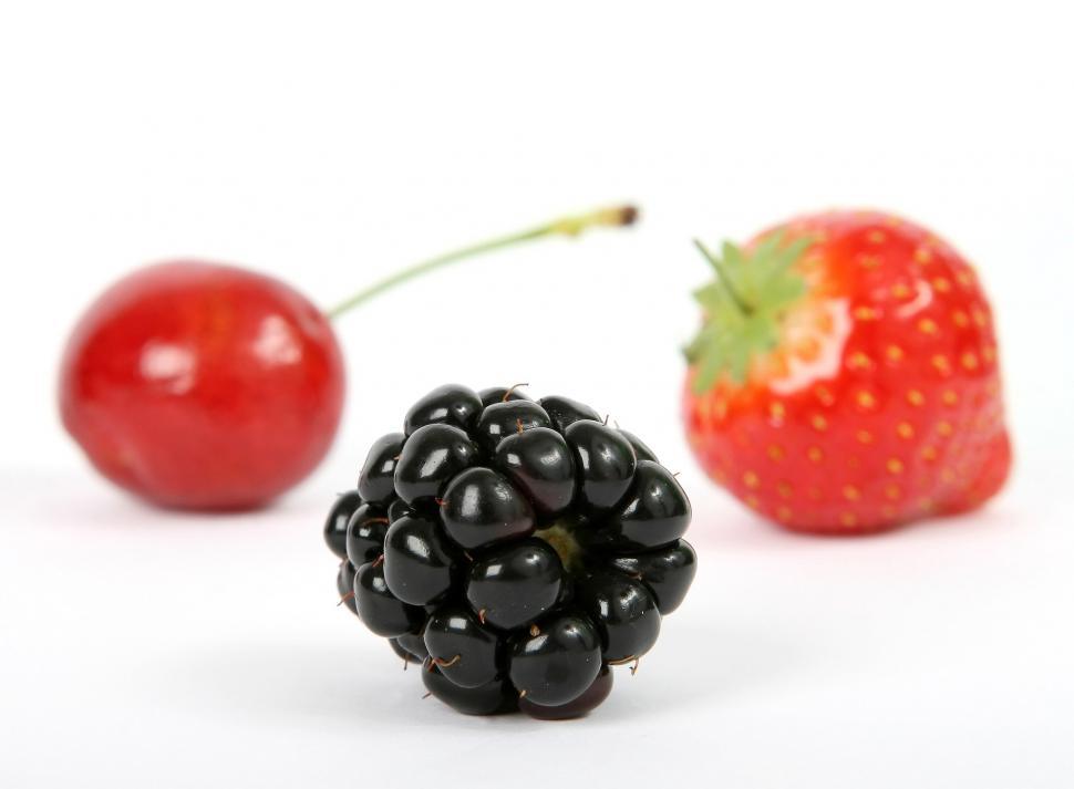 Free Image of Two Berries and a Strawberry on a White Background 