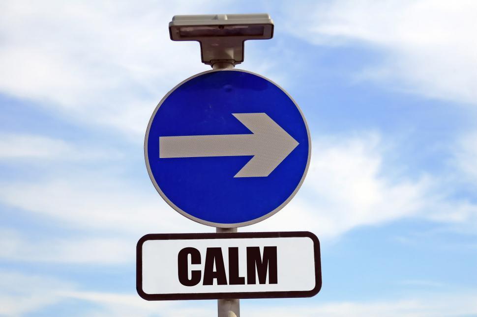 Free Image of Street Sign With Arrow Pointing to Calm 
