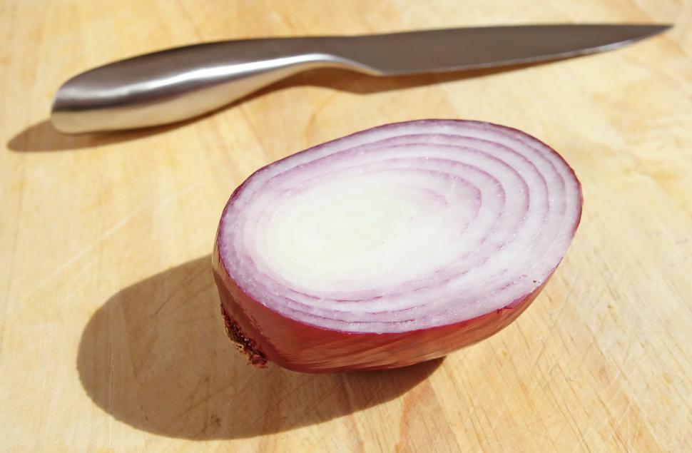 Free Image of Knife and Onion on Cutting Board 