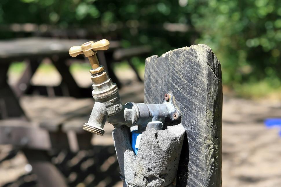 Free Image of Close Up of Water Faucet on Wooden Bench 