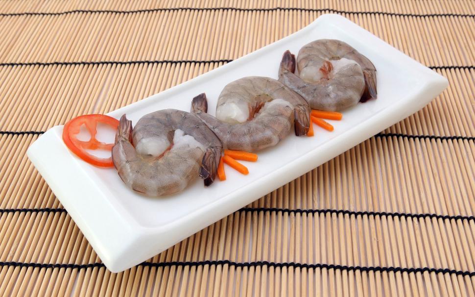 Free Image of White Plate With Three Shrimp on Bamboo Mat 