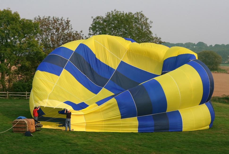Free Image of Large Yellow and Blue Kite on Lush Green Field 