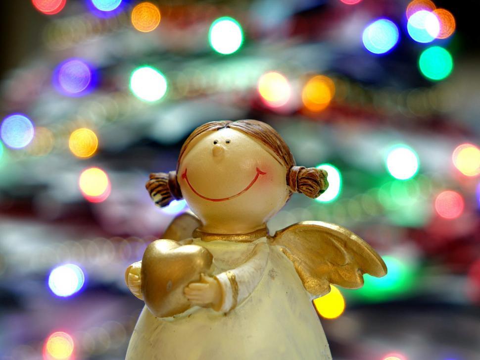 Free Image of Small Angel Figurine by Christmas Tree 