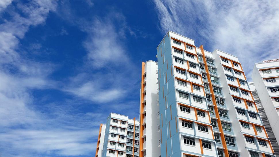 Free Image of Tall White and Orange Building Under Blue Sky 