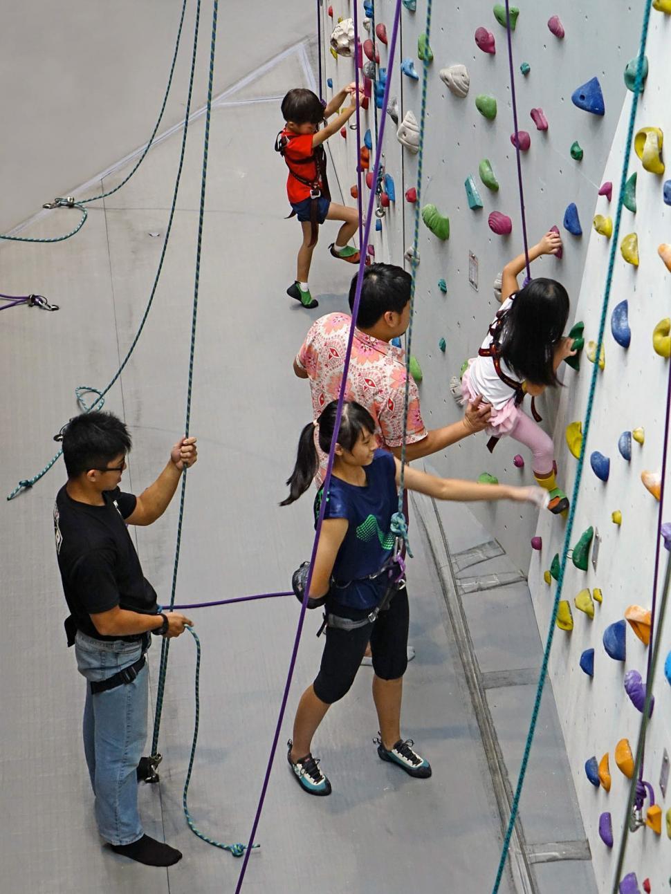 Free Image of Group of People Climbing Up Wall 