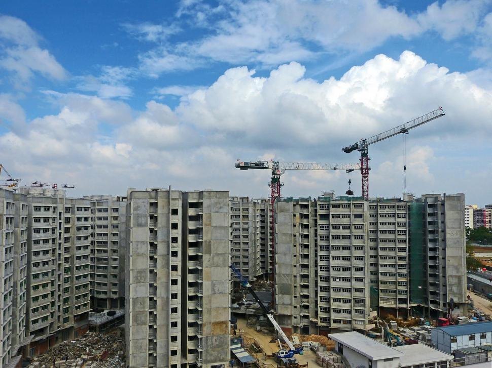 Free Image of Large Building Under Construction With Cranes in Background 